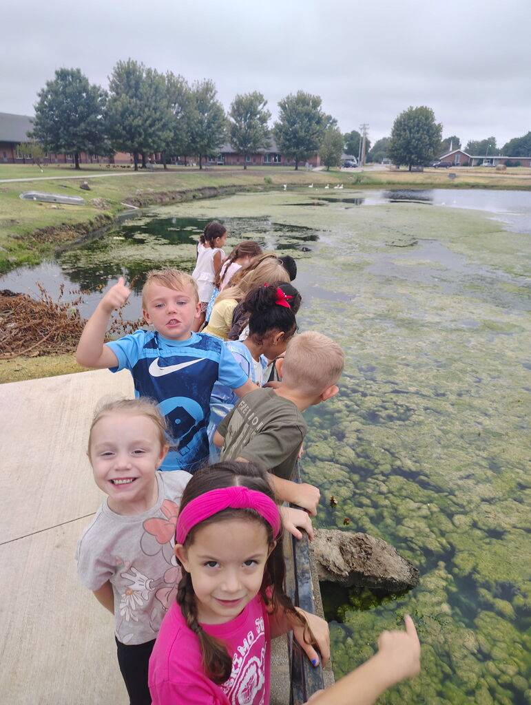 Kids posing by the pond at the Commons