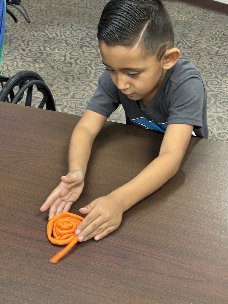 Little boy playing with playdoh