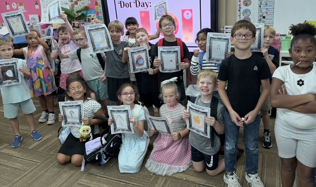 Kids posing with their colorful pictures of dots