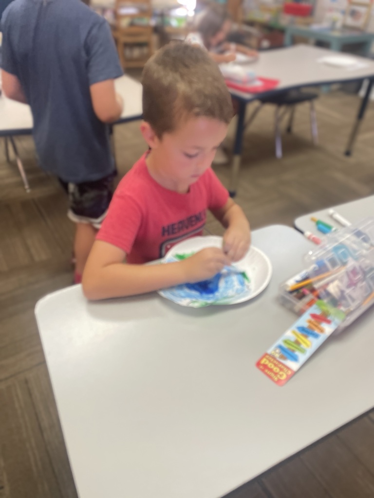Little boy working on her dot drawing