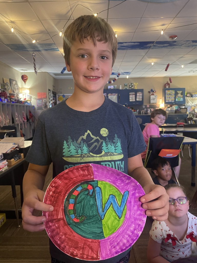 Boy posing with his painted dot pictue
