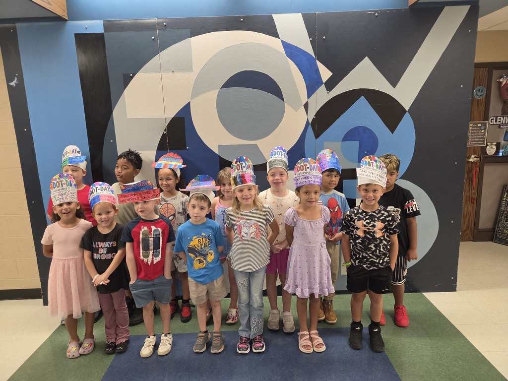 A group of students showing off their dot art and outfits