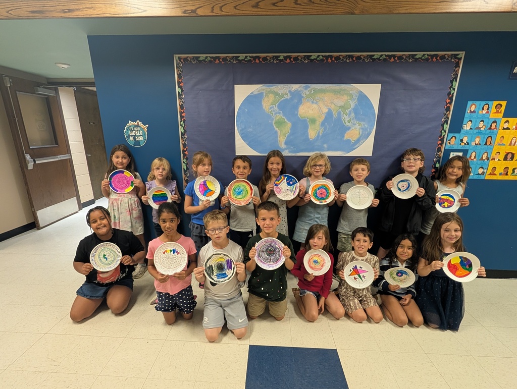 Class posing with their dot art