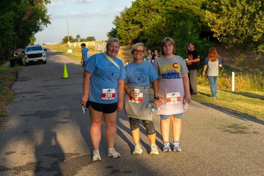 Sarah Owens, Holly Day and Glenwood student pose after running