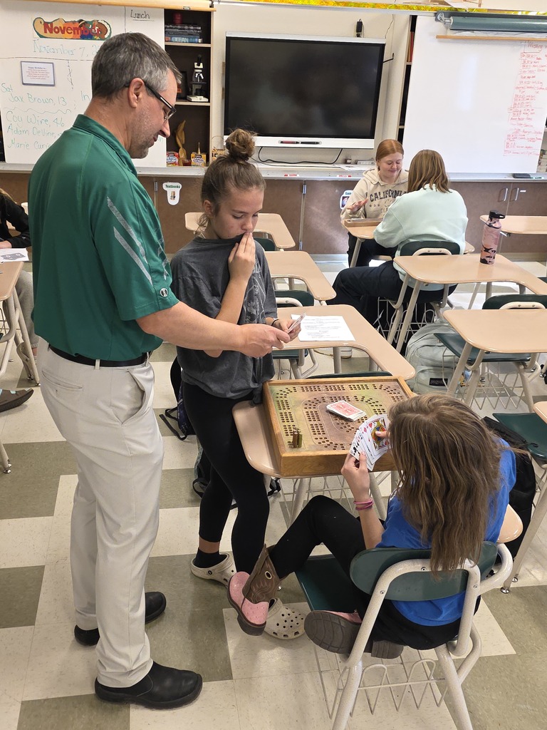 Mr. Moretti teaching a couple of 7th Grader's the game of Cribbage