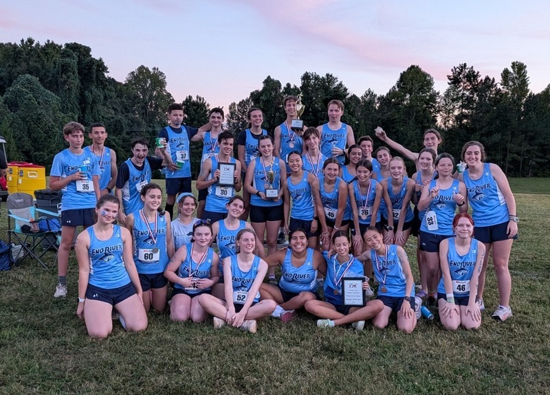 Middle school and high school children posing after a cross country meet