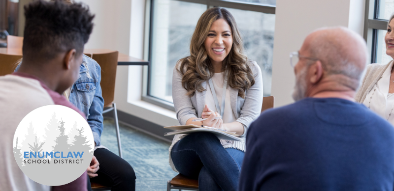 Banner image showing a small group of adults seated in a circle during a discussion in a bright meeting space. On the right side, a dark blue panel reads “ESD Elementary #6 – Join Our New School Naming Committee.” The Enumclaw School District logo appears on the left side of the image