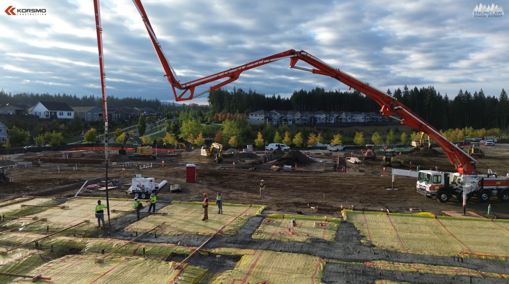 Drone image of the job site as workers pour concrete