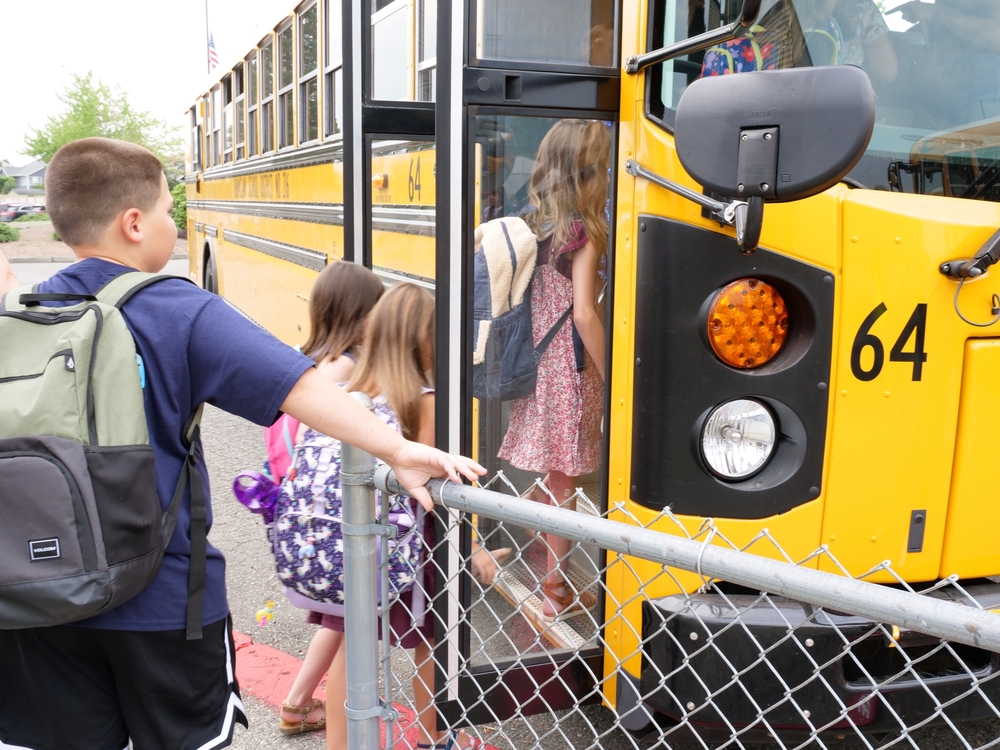 students walking onto school bus