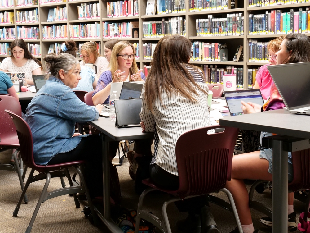 Special education staff at a full day pd discussing instructional practices in the EHS library