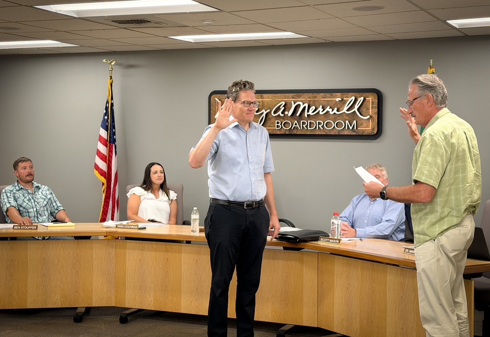 Dr. Wenzel taking the oath of office at the board meeting with director Fisher