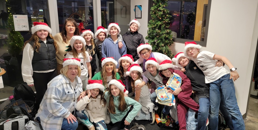 Kibler students donating $500 after kibler coin drive- students posed for group picture in santa hats
