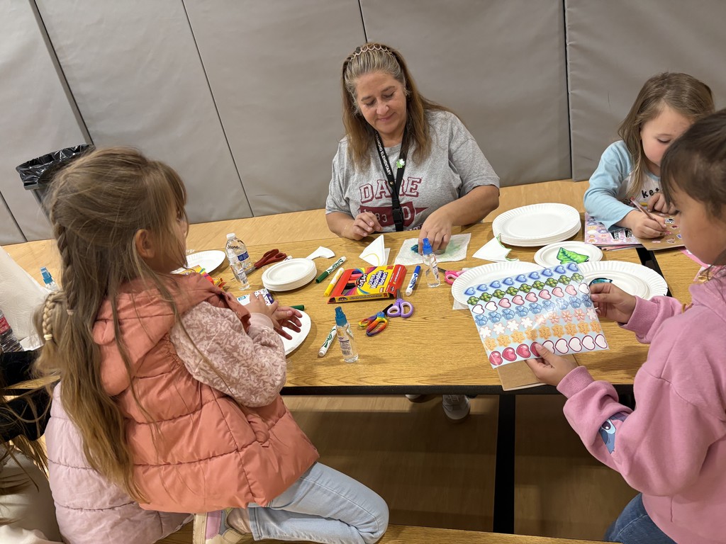 Mrs. Stone doing art with our students.