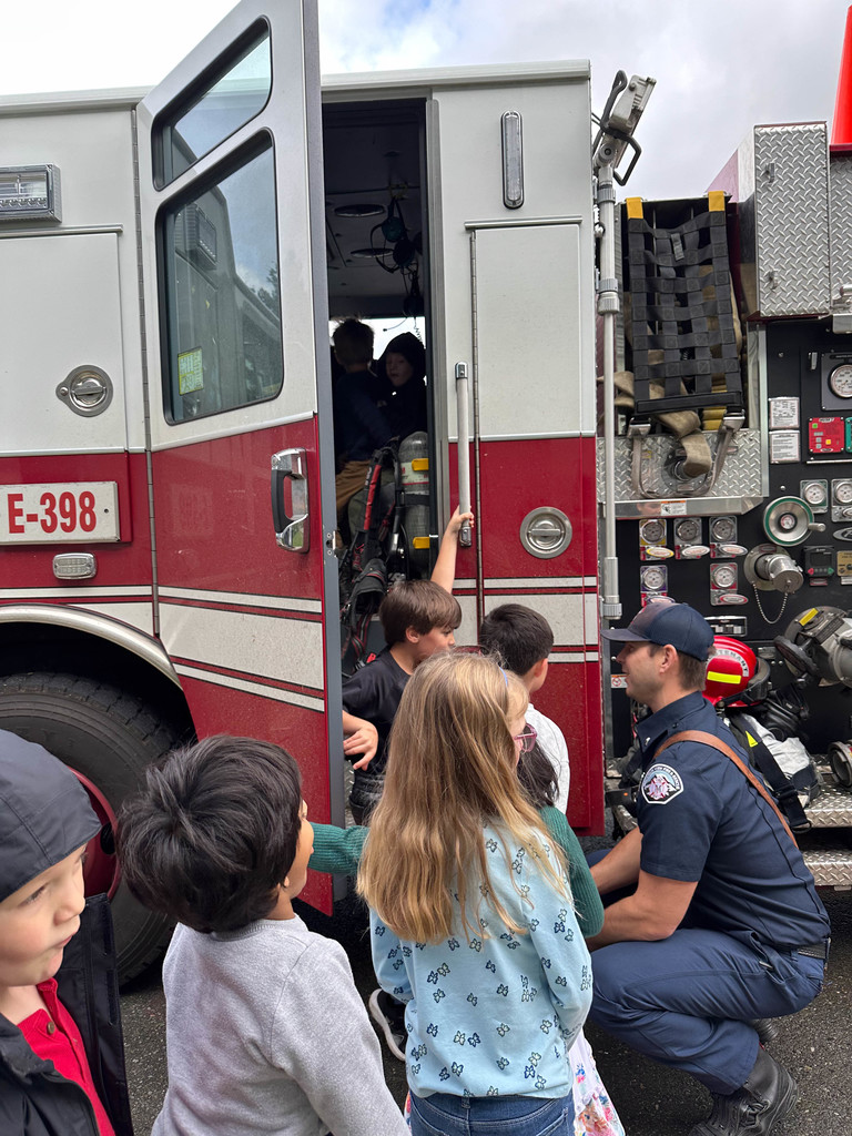 Students enjoying time visiting the firetruck and firefighters.