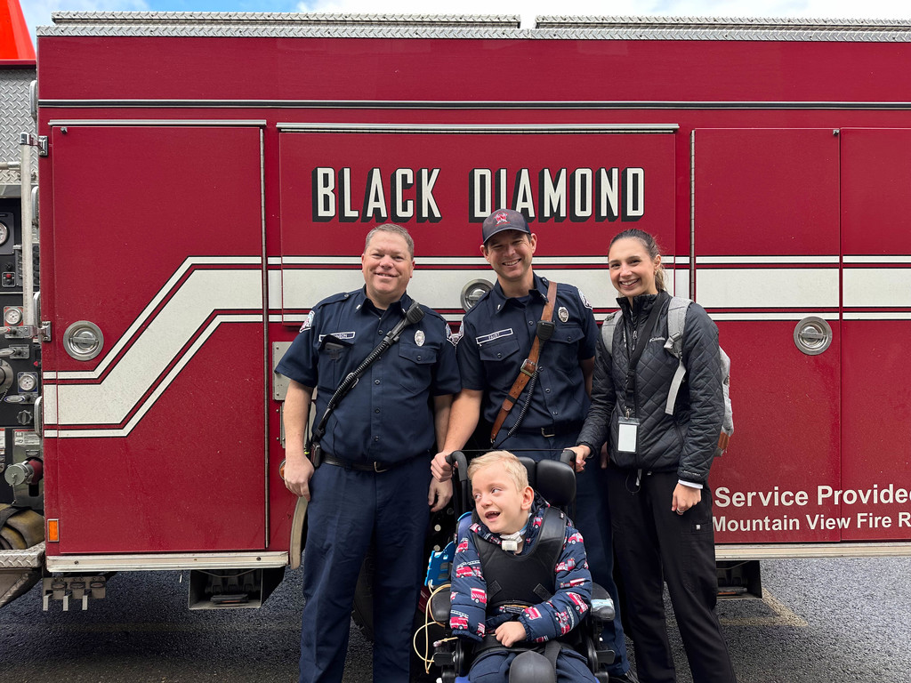 Students enjoying time visiting the firetruck and firefighters.