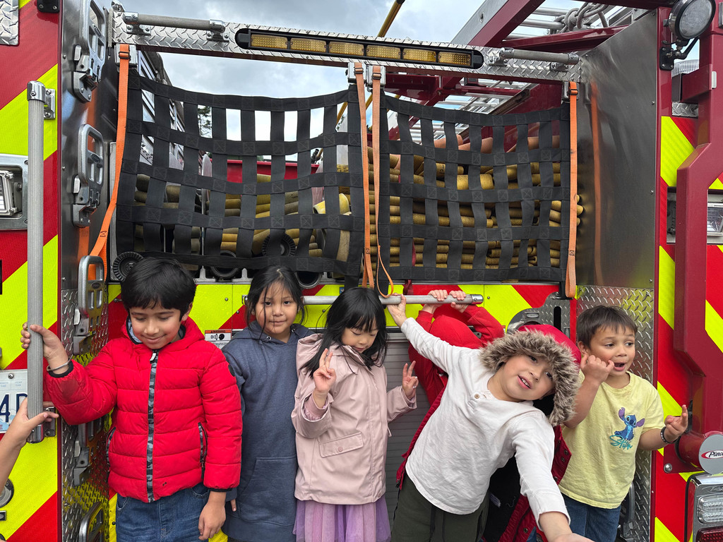 Students enjoying time visiting the firetruck and firefighters.