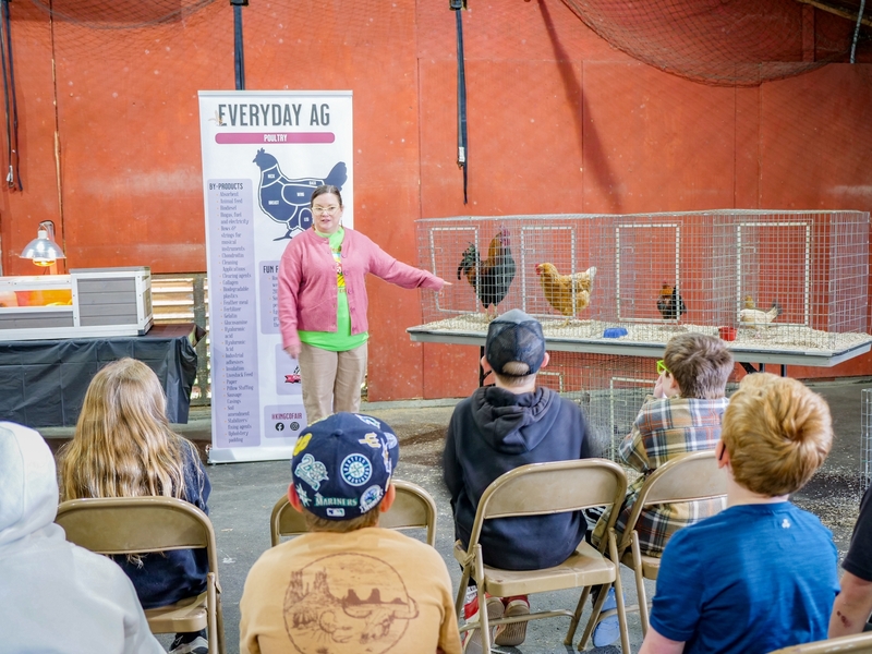 students listening to talk about poultry with live poultry in cages