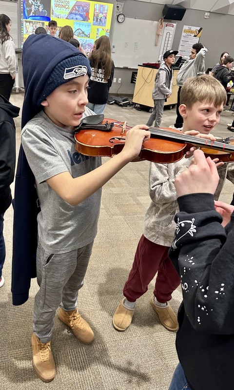 Student tries a violin
