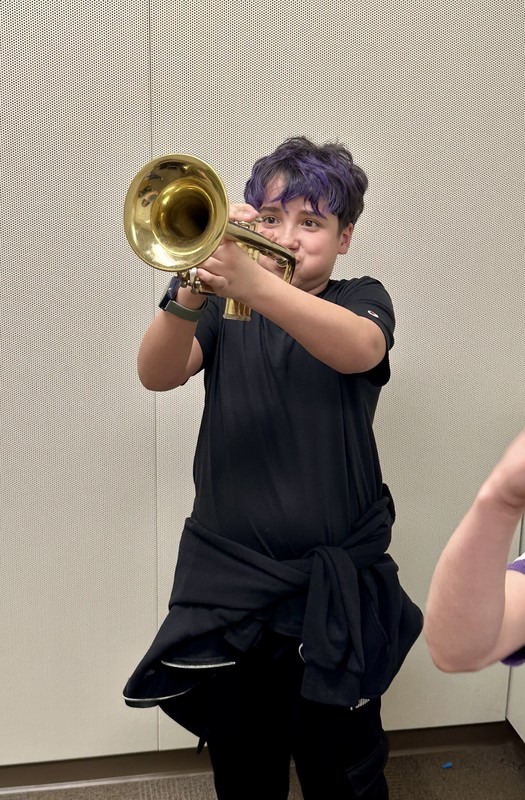 student tries a trumpet