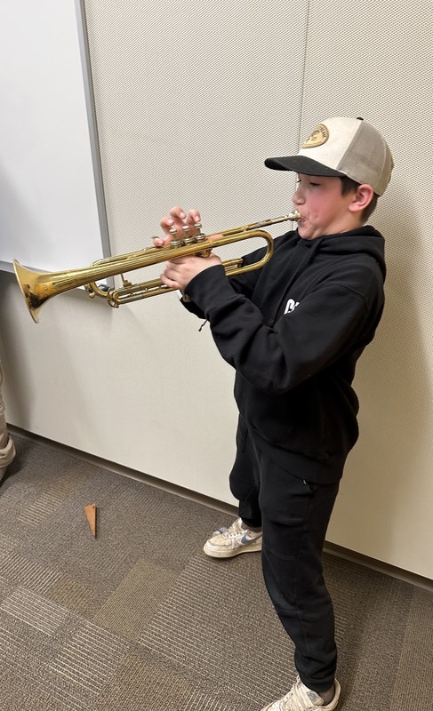 student tries a trumpet