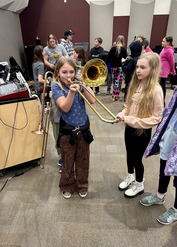 student tries a trombone