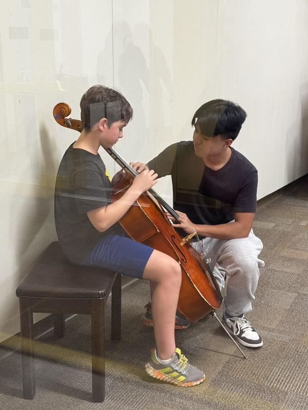 student tries the cello