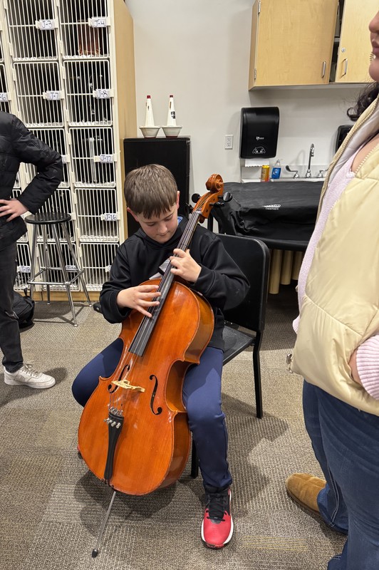 student tries the cello
