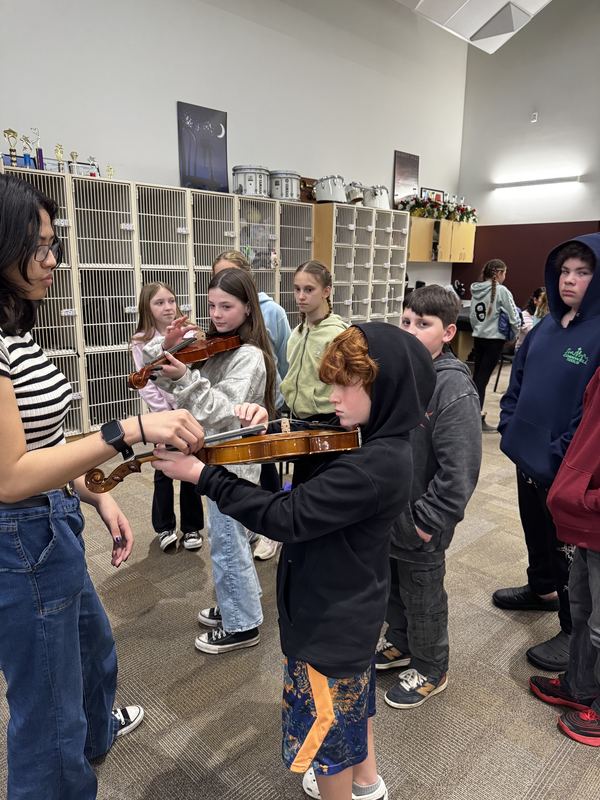 student tries the violin