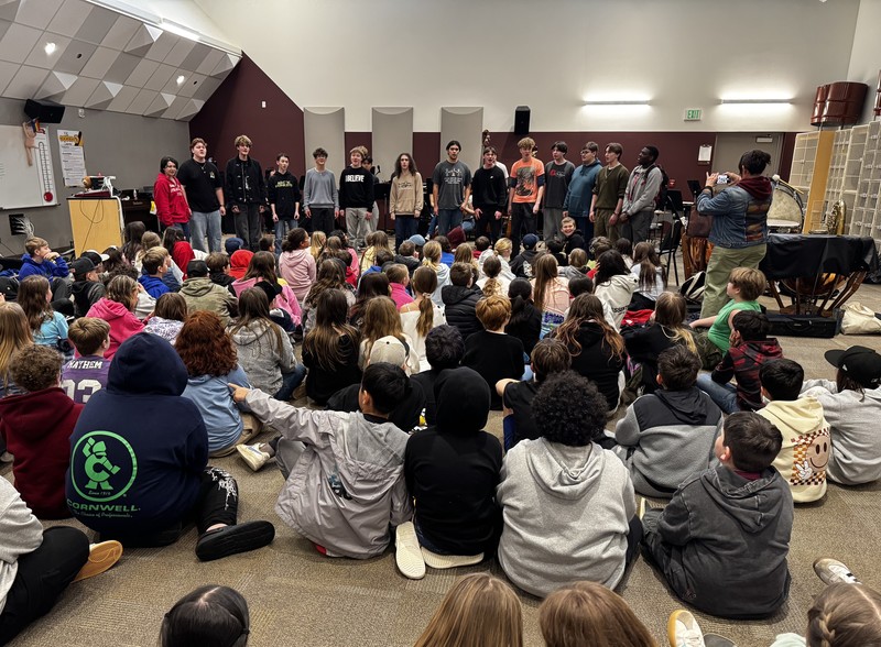 students listen to a choir performance