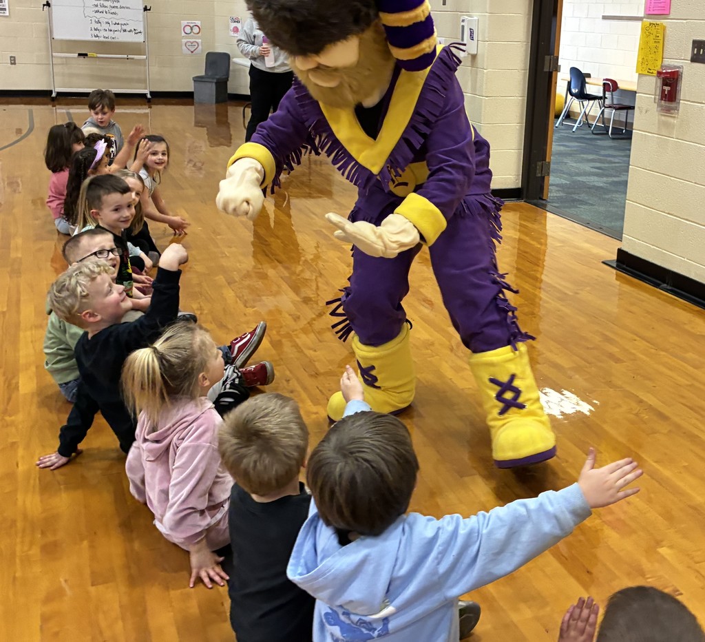 Cliff high-fiving a row of students
