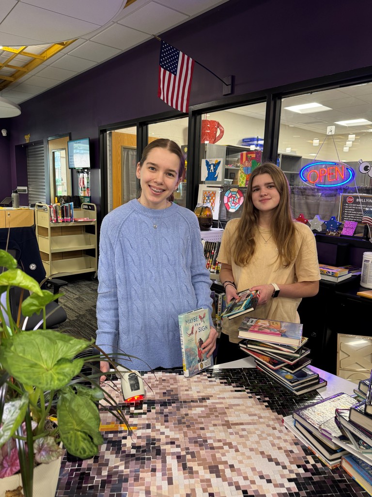 Two EMS students with books in the media center