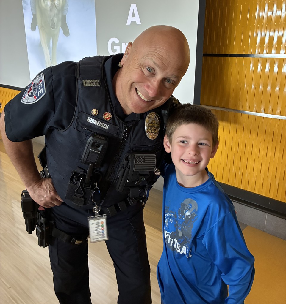 Officer Hirneisen and student smiling for the camera