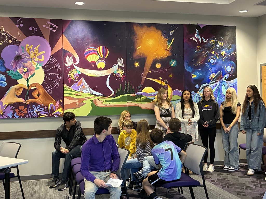 Students unveiling the board room mural 