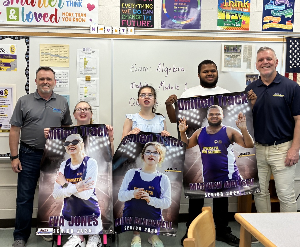 Unified Track seniors holding banners