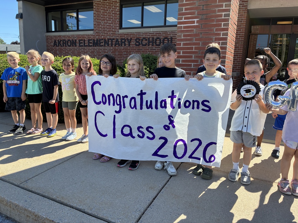 Students with Graduation Banner