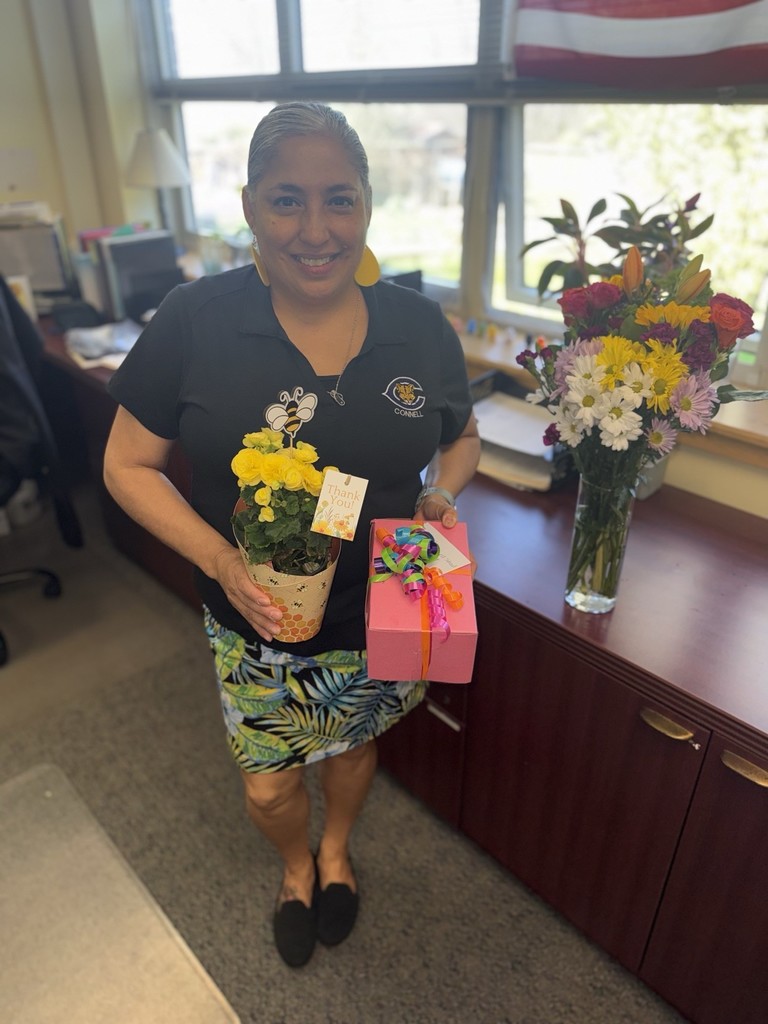 Our secretary is being celebrated for National Administrative Assistant Day with flowers and cookies.