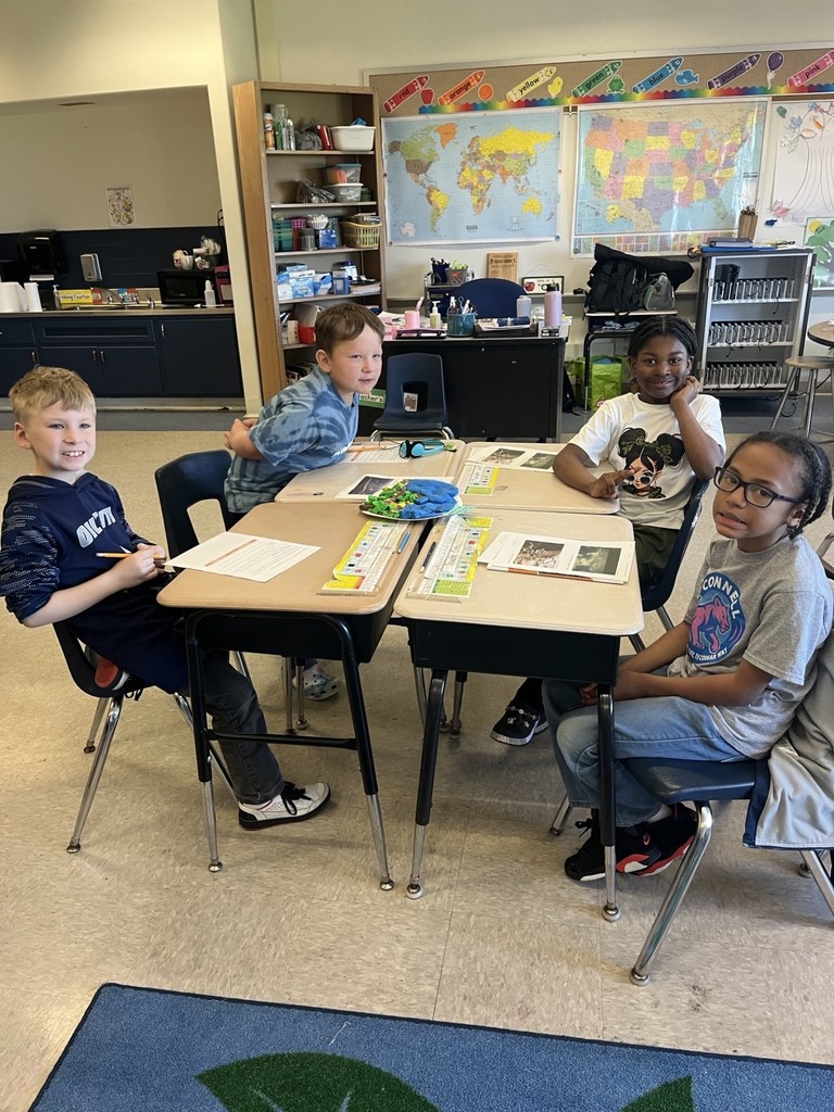 students working together to build their clay models of a national park.