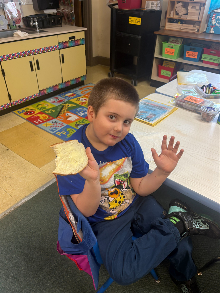 Student enjoying butter they made on a piece of bread.