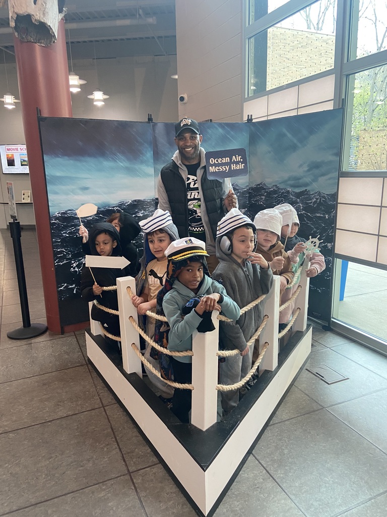 A teacher and his students pretending to be sailors in a boat at their field trip today. 