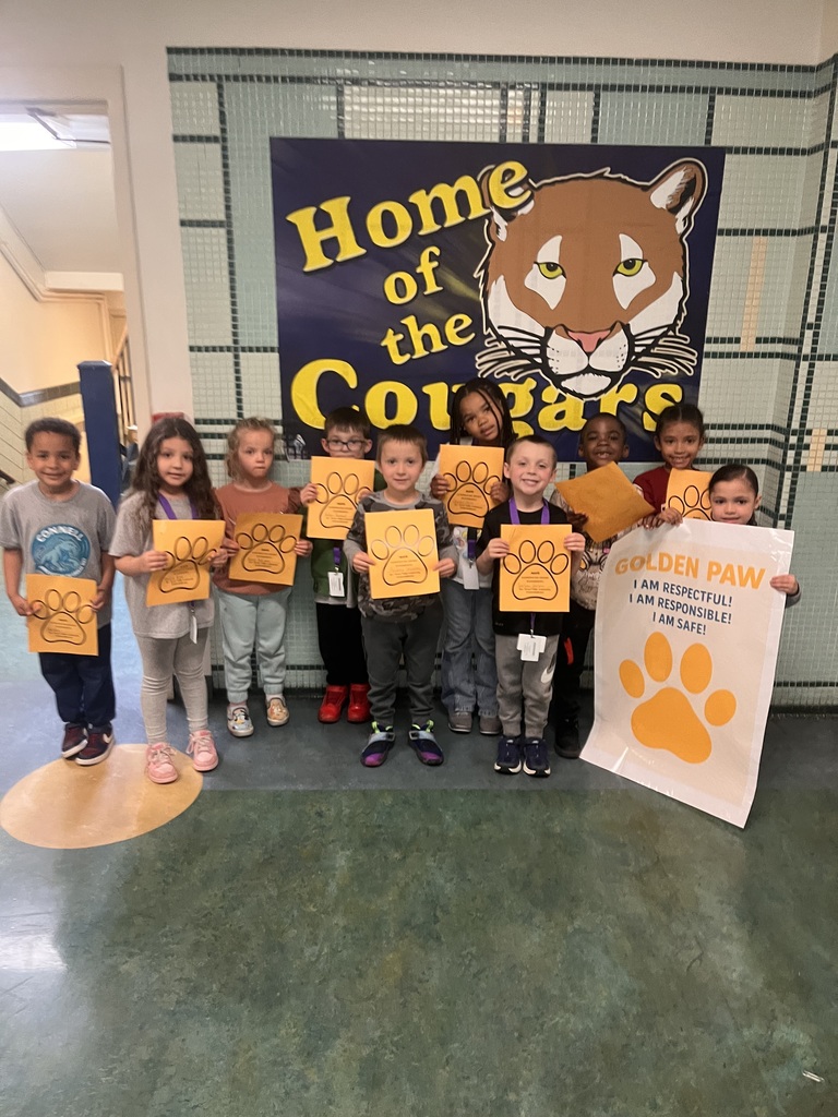 students who got a golden paw award for the month of april are pictured holding their certificates. 