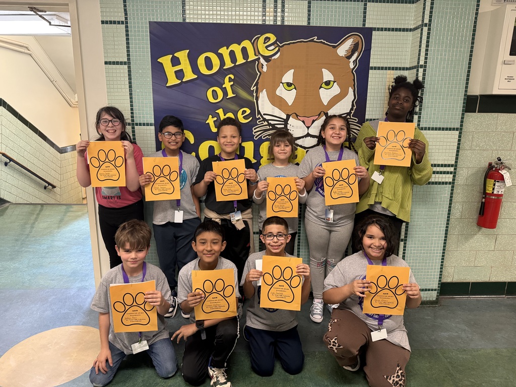 students who got a golden paw award for the month of april are pictured holding their certificates. 