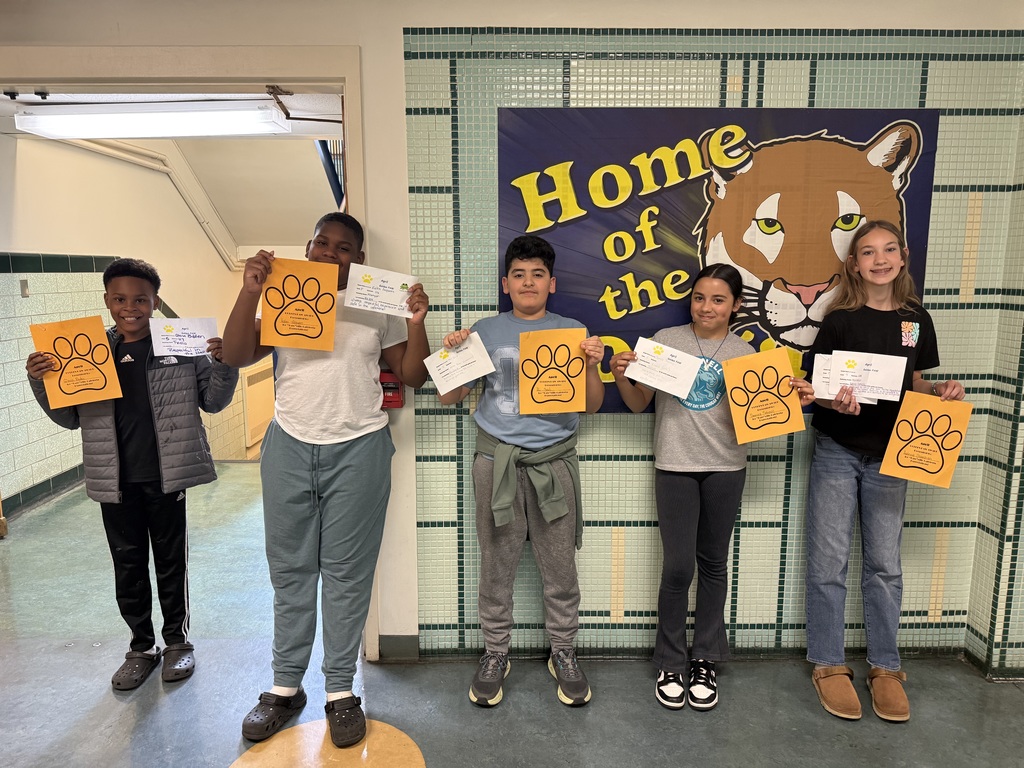 students who got a golden paw award for the month of april are pictured holding their certificates. 