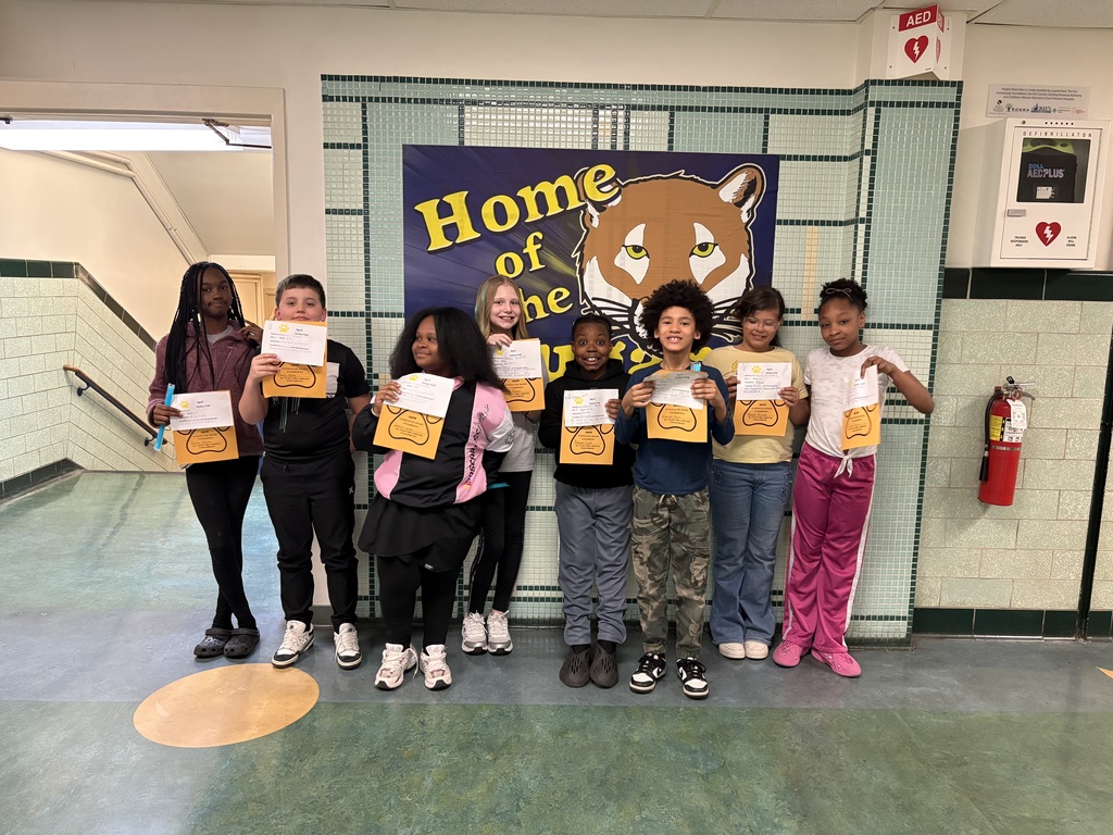 students who got a golden paw award for the month of april are pictured holding their certificates. 