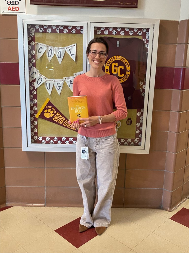 Picture of teacher holding book for staff shout out