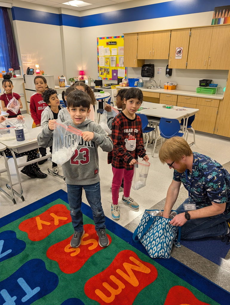 Edison students doing an activity with Wabtec volunteers.