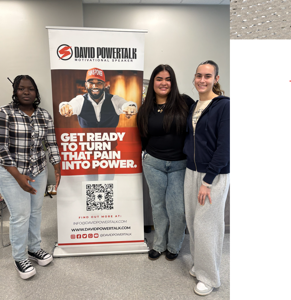 Erie High students standing in front of the David Powertalk banner.