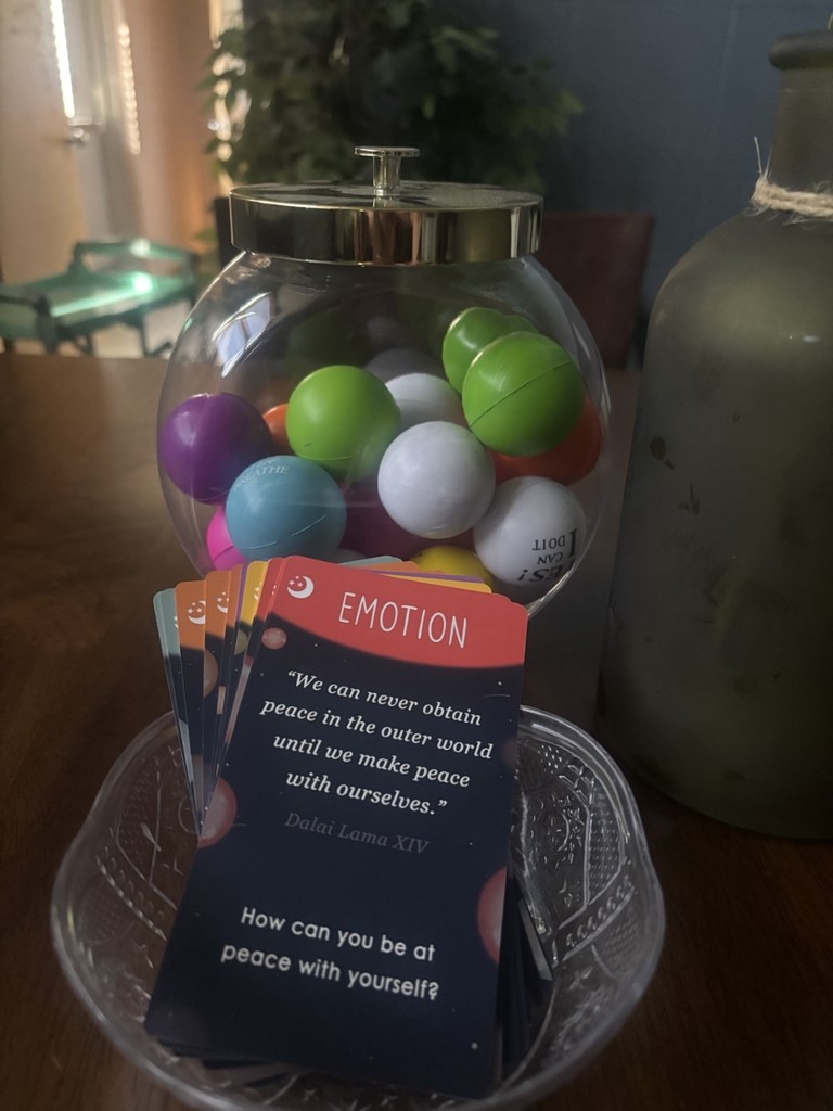 Picture of jar with stress balls and a card that reads "Emotion: We can never obtain peace in the outer world until we make peace with ourselves. -Dalai Lama XIV How can you be at peace with yourself?"