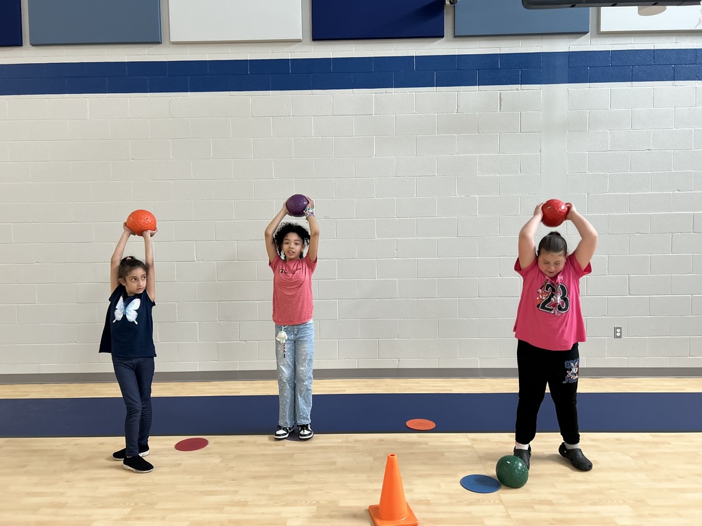 Students in gym class lifting weights.