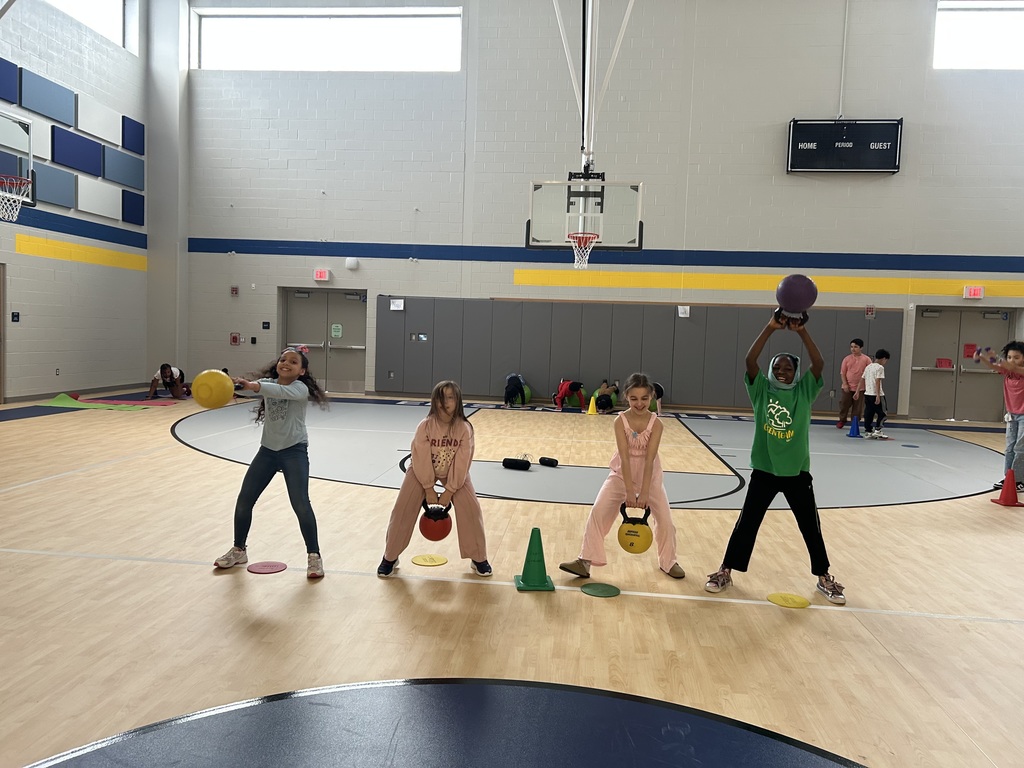 Students in gym class lifting weights.