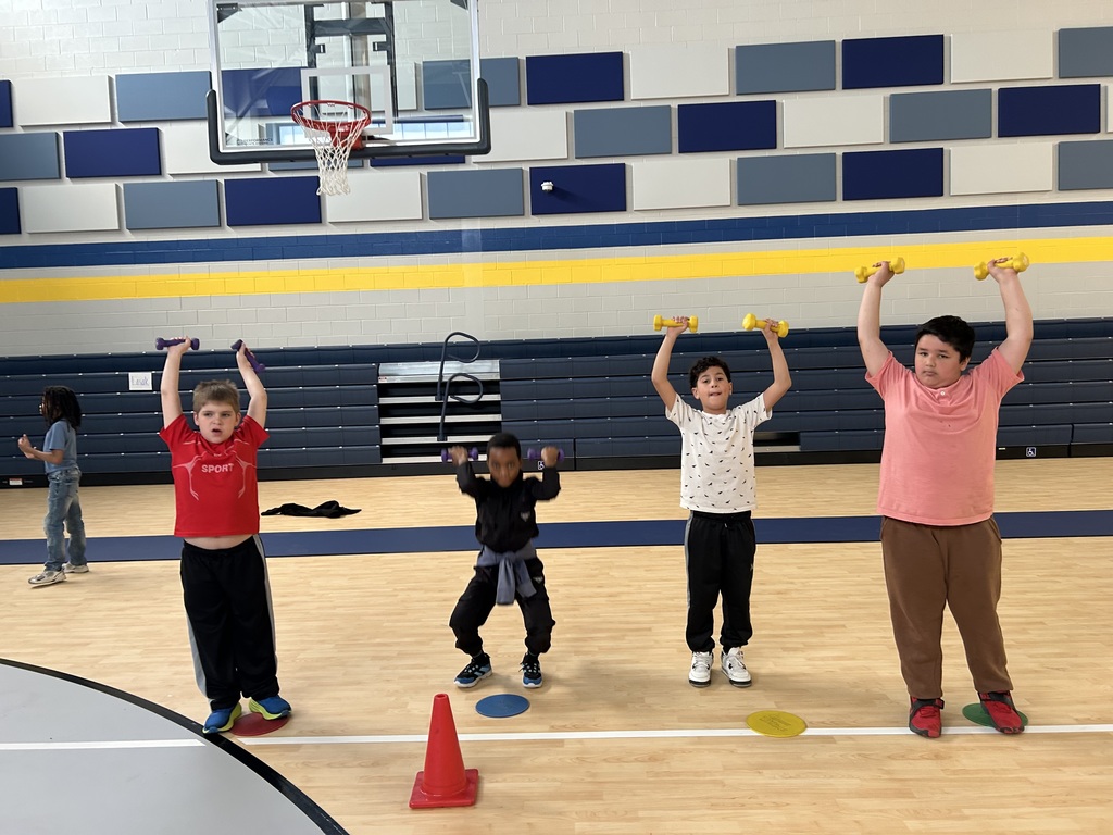 Students in gym class lifting weights.
